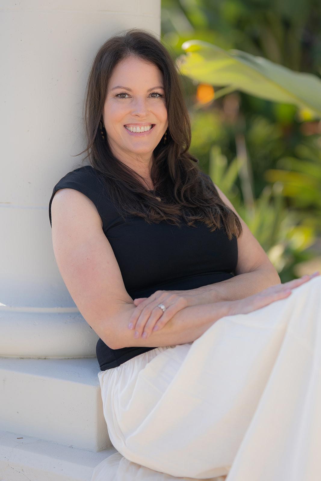 Woman with dark brown hair standing